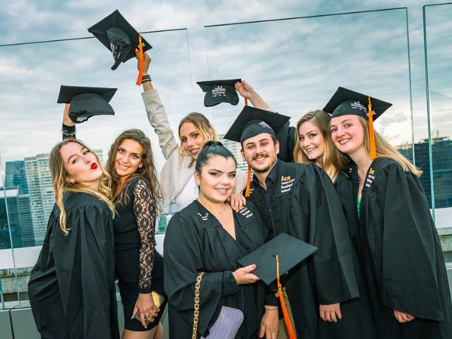 ICN student graduates celebrating on the campus balcony at ICN Business school in Paris, France